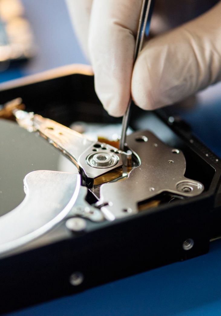 closeup-hands-with-tweezers-computer-hard-disk